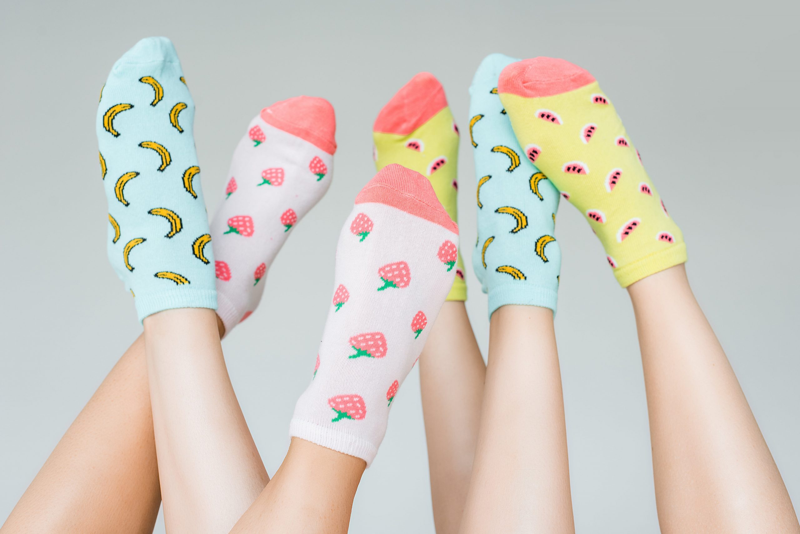 female feet in colorful fruity socks